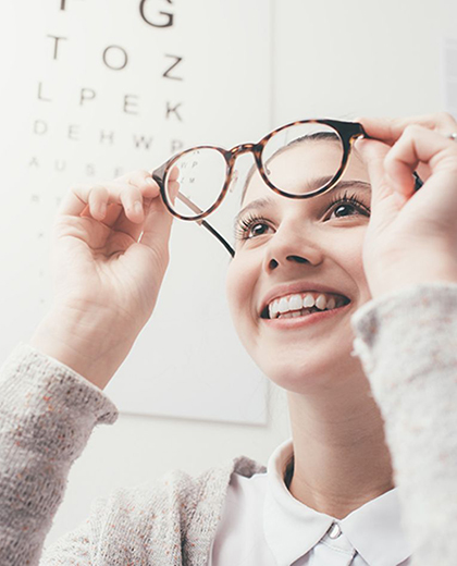 Happy woman trying her new glasses